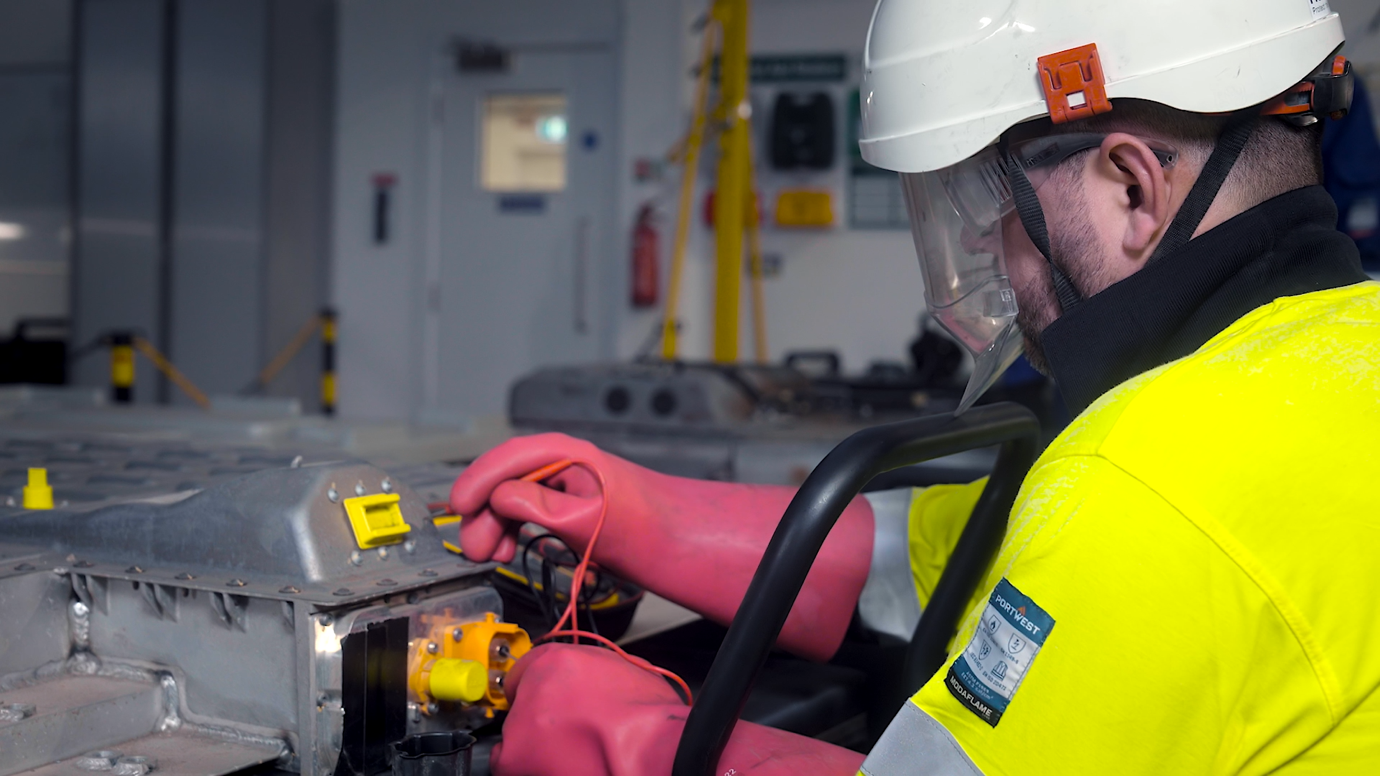 A person in a helmet and gloves working on a machine

AI-generated content may be incorrect.