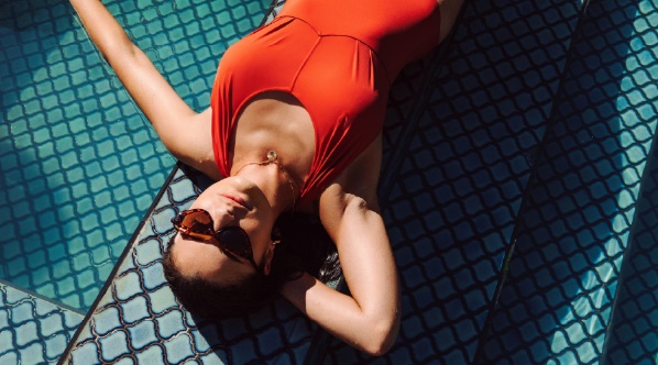 A person lying on the ground wearing a swimsuitDescription automatically generated