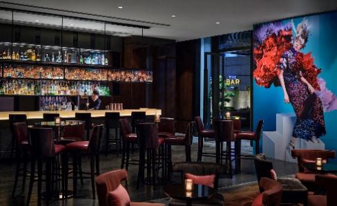 A bar with a person behind the counter

Description automatically generated